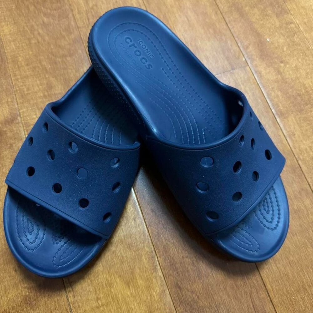 Navy blue Crocs Classic Slide sandals.